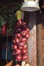 Garland of red garlic hanging on the wall