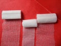 Gauze rolls for wound healing with red background