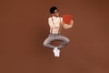 Photo of geek guy jump hold open book read interesting story wear suspenders shoes isolated brown color background Royalty Free Stock Photo