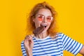 photo of girl eat icelolly ice cream at summer. girl with icelolly ice cream isolated on yellow.