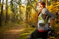 Photo of girl in helmet on bicycle in autumn forest