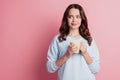 Photo of girl hold cup drink coffee look side empty space think inspiration pause concept