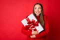 Photo of girl hug gift box look copyspace wear jumper isolated over bright shine red color background Royalty Free Stock Photo