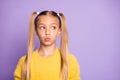 Photo of girl looking into empty space with her lips pouted pastel violet color background