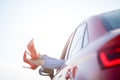 Photo of girl`s legs in red shoes sticking out of red car window Royalty Free Stock Photo