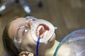 Photo of a girl sitting in a dentist`s chair, pediatric dentistry, dental treatment, toothache Royalty Free Stock Photo