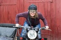 Photo of girl on a vintage motorbike in pilot cap Royalty Free Stock Photo