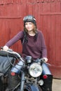 Photo of girl on a vintage motorbike in pilot cap Royalty Free Stock Photo