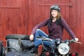 Photo of girl on a vintage motorbike in pilot cap Royalty Free Stock Photo