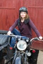 Photo of girl on a vintage motorbike in pilot cap Royalty Free Stock Photo