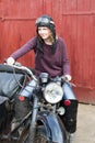 Photo of girl on a vintage motorbike in pilot cap Royalty Free Stock Photo