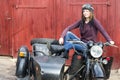 Photo of girl on a vintage motorbike in pilot cap Royalty Free Stock Photo