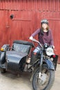 Photo of girl on a vintage motorbike in pilot cap Royalty Free Stock Photo
