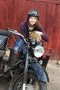 Photo of girl on a vintage motorbike in pilot cap with cat Royalty Free Stock Photo