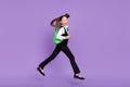 Photo of glad cheerful impressed schoolgirl jump run wear rucksack uniform isolated violet color background