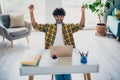 Photo of glad cheerful positive man sitting table completing finishing tasks project startup shouting yes hooray indoors Royalty Free Stock Photo