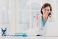 Photo of glad woman therapist or physician has phone conversation with patient, gives advice how to cure disease, wears white gown