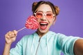 Photo of glamour woman 20s in sunglasses holding big candy and t Royalty Free Stock Photo