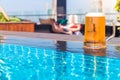 A glass of beer on a sunny day by the pool Royalty Free Stock Photo