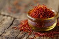 A photo of a glass jar filled with saffron placed on top of a wooden table, Cupful of saffron threads, rich red colour, AI
