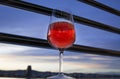 A glass of red wine on the balcony in the evening Royalty Free Stock Photo
