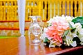 Photo of a glass well design on the table with a pinkish color flower on the side