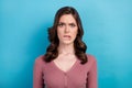 Photo of gloomy angry dissatisfied woman with wavy hairdo dressed pink cardigan biting lips staring isolated on blue Royalty Free Stock Photo