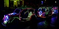 Photo of glowing LED lights in a row and in the shape of a classic car