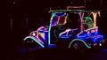 Photo of glowing LED lights in a row and in the shape of a classic car