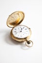 Golden pocket stopwatch over white background