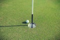 Photo of Golf ball at edge of hole Royalty Free Stock Photo