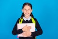 Photo of good mood cheerful smiling clever girl hug embrace book wear backpack isolated on blue color background