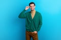 Photo of good mood confident man wear green cardigan arm spectacles smiling isolated blue color background Royalty Free Stock Photo