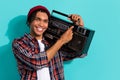 Photo of good mood guy dreadlocks wear plaid shirt make music louder hold boombox on shoulder isolated on turquoise