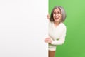 Photo of good mood laughing grandmother hide behind huge whiteboard banner empty space mockup menu isolated on green