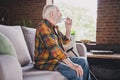 Photo of good mood man pensioner wear checkered shirt drinking fresh water glass indoors house room Royalty Free Stock Photo