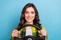 Photo of good mood pretty girl curly hairdo dressed checkered shirt holding steering wheel buy new car isolated on blue Royalty Free Stock Photo