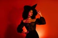 Photo of gorgeous goth dark witch on sabbath celebrate halloween holiday over red background