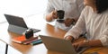 Photo of graphic designer team working together with computer laptop and tablet at the wooden working desk. Royalty Free Stock Photo