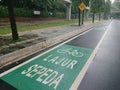 Green bicycle track and road sign in indonesia language, jalur sepeda Royalty Free Stock Photo