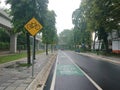 Green bicycle track and road sign in indonesia language, jalur sepeda Royalty Free Stock Photo