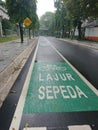 Green bicycle track and road sign in indonesia language, jalur sepeda Royalty Free Stock Photo