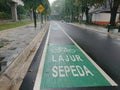 Green bicycle track and road sign in indonesia language, jalur sepeda Royalty Free Stock Photo