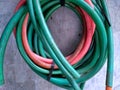 a photo of green and pink water hose reels.