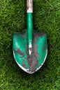 Photo of green shovel with soil on grass Royalty Free Stock Photo