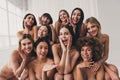 Photo of group beautiful women in brassieres touch skin after spa procedures at studio white color background