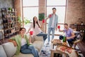 Photo of group carefree positive people have good mood hold plastic beer cups enjoy pastime chill apartment inside Royalty Free Stock Photo