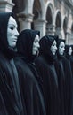 photo of a group of people wearing expressionless white masks and black hooded robes