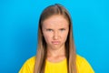Photo of grumpy frustrated small lady frowning face grimace wear yellow t-shirt isolated blue color background