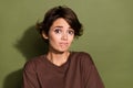 Photo of guilty confused clueless woman with bob hairdo dressed brown t-shirt sadly look at camera isolated on khaki